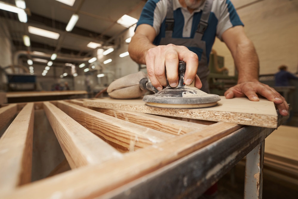 Close,Up,Of,Male,Hand,Grinding,Mdf,Plate